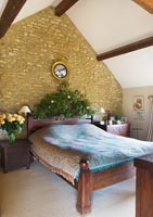 Country bedroom with Ivy decorated headboard at Christmas