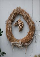 Simple Christmas wreath of moss, twigs and cones