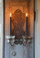 Decorative candle sconces on shutter