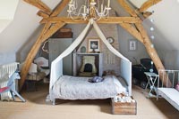 Childs bedroom with canopy and vintage quilt
