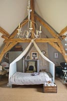 Childs bedroom with canopy and vintage quilt