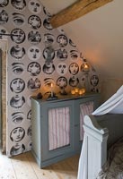 Faces wallpaper and vintage cabinet