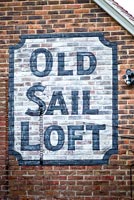 Painted sign on red brick wall