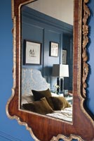 Classic bedroom reflected in antique mirror