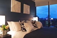 Modern bedroom lit up at night
