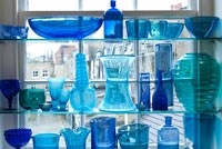 Display of blue glassware at window