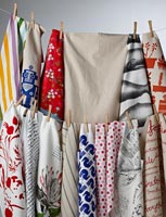 Colourful tea towels hanging on washing line
