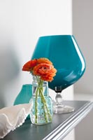 Orange flowers in glass vase