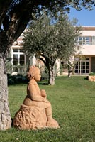 Terracotta sculpture under Olive tree