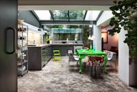 Colourful kitchen diner with concrete floor