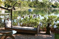 Daybed on patio by lake