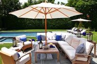 Wooden patio furniture next to pool