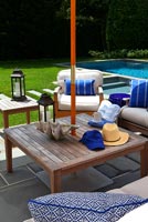 Wooden patio furniture next to pool