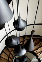 Modern pendant lights hanging over spiral staircase