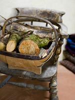 Trug of logs on wooden chair