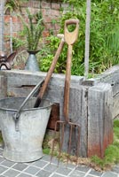 Vintage gardening tools by raised bed