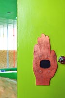 Hand artwork on lime green wall