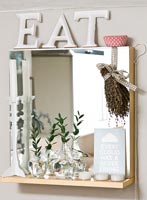 Decorative objects on kitchen mirror