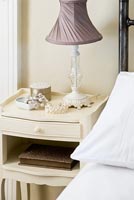 Grey lamp on bedside cabinet