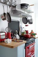 Kitchen storage above red cooker