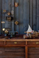Display of vintage cameras and objects on wooden cabinet