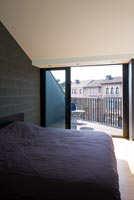 Contemporary bedroom with balcony