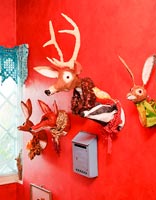Kitsch ornaments mounted on red wall