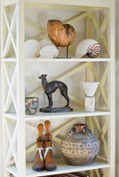 Collectibles on white shelving unit