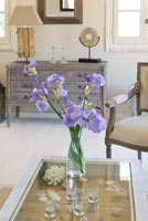 Purple Irises on glass coffee table
