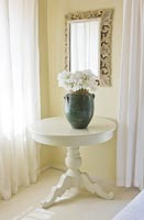 Vase of white Irises on circular table