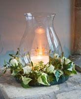 Wreath of Ivy, Roses and Mistletoe around jar with candle