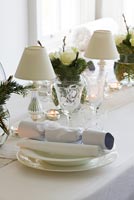 White dining table decorated for christmas meal