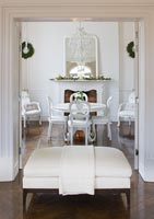 White dining room decorated for Christmas