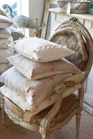 Floral cushions stacked on chair