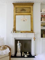 Period fireplace and ornate mirror