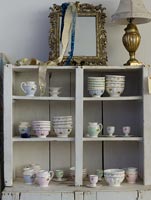 Vintage crockery displayed on grey shelves