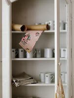 White crockery in painted cabinet
