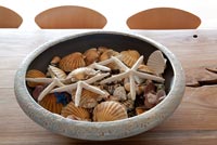 Bowl of seashells on rustic table
