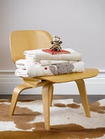 Child's clothing piled on plywood chair