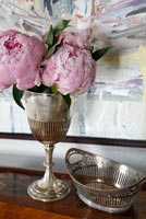 Peonies in classic silver vase
