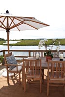 Wooden table and chairs overlooking lake
