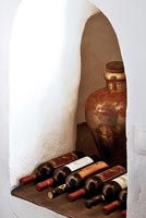 Wine bottles stored in alcove