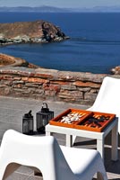 White chairs on patio with sea view 
