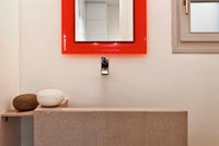 Minimal sink and red mirror frame