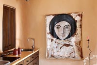 Large painting in wooden kitchen