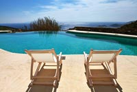 Deck chairs by swimming pool