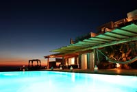 Luxury swimming pool lit up at night