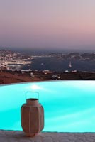 Luxury swimming pool lit up at dusk