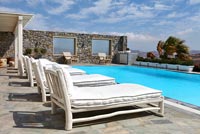 White loungers by pool