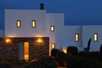 Minimal Greek villa lit up at night